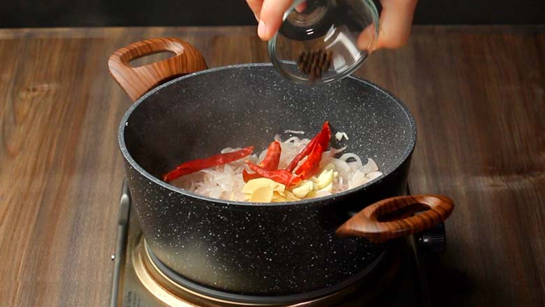 Add sliced ginger, garlic, dried red chillies, and black peppercorns to the softened onion - Rampur Mutton Stew Recipe