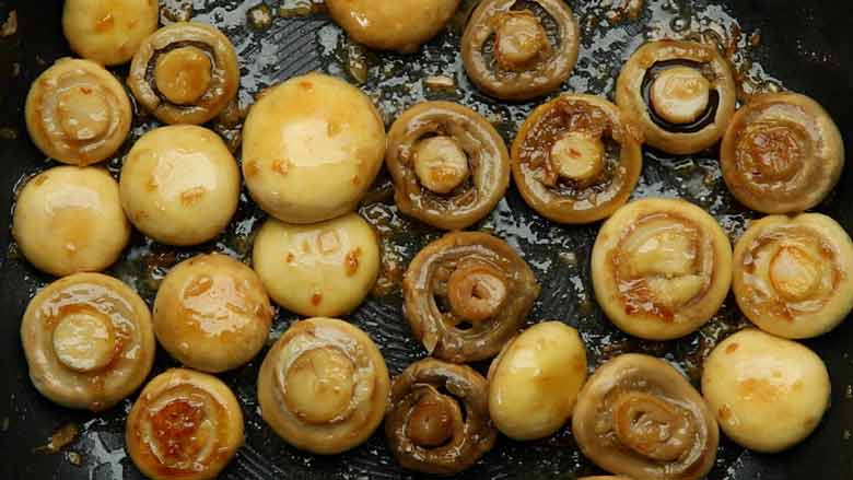Turn mushrooms occasionally so that they cook evenly - Garlic Butter Mushrooms Recipe