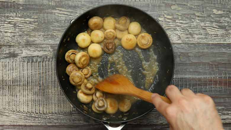 Add wine and cook till the wine evaporates - Garlic Butter Mushrooms Recipe