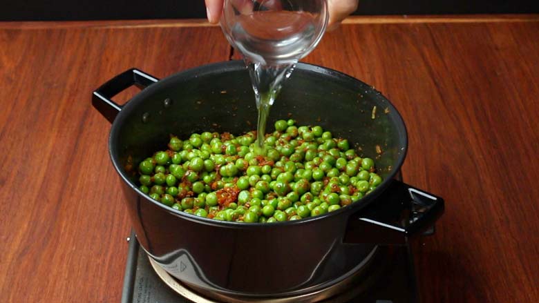 Add 1 tbsp water and cover and cook matar ki sabji till done - Green Peas Masala Recipe