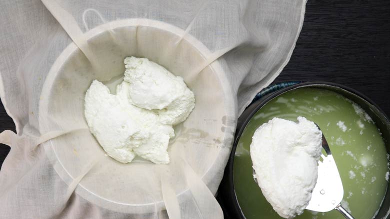Pour or spoons curds into a muslin cloth over a colander. Allow to drain for 2 - 3 minutes - How to make paneer from milk at home