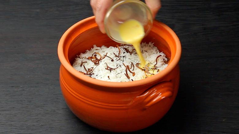 Layer with rice again, then top with birista (fried onions), saffron soaked in milk, lime juice, and ghee. Place on dum for 10 - 15 minutes - Hyderabadi Dum Biryani Recipe
