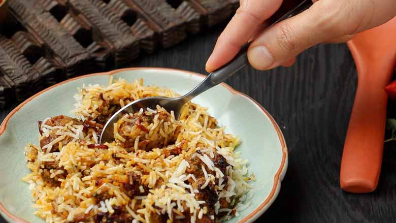 Serve Mutton Dum Biryani hot with raita, kachumber, and mirch ka salan - Hyderabadi Dum Biryani Recipe