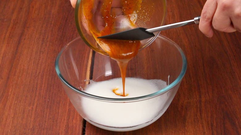 Pour yolk-spice mixture into the beaten egg whites and gently mix - Masala Omelette Recipe