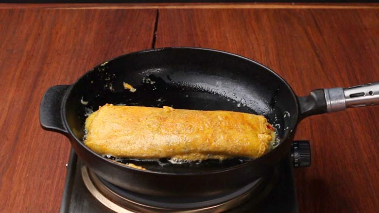 Reduce heat to low and cook omelette till golden and cooked through, 1 to 1 1/2 minutes - Indian Masala Omelette Recipe