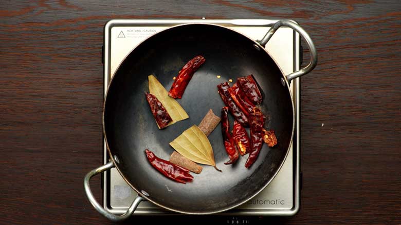 Dry roast dried red chillies, cinnamon stick (dalchini), and bay leaf (tej patta) for a minute over medium-low heat - Pav Bhaji Masala Powder Homemade Recipe
