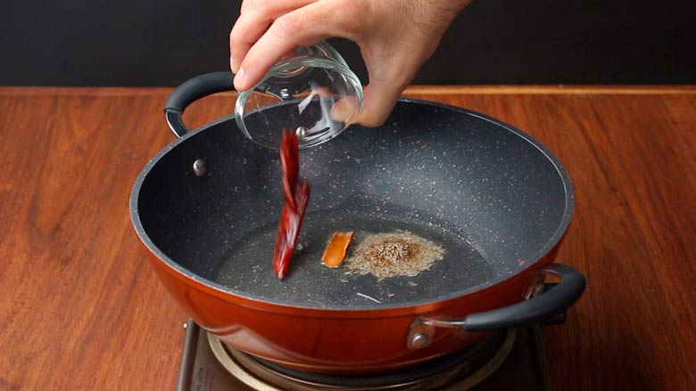 Add the cinnamon, cumin seeds, and dried red chillies to ghee in a kadhai. Sauté about 1 minute - Punjabi style Rajma Recipe