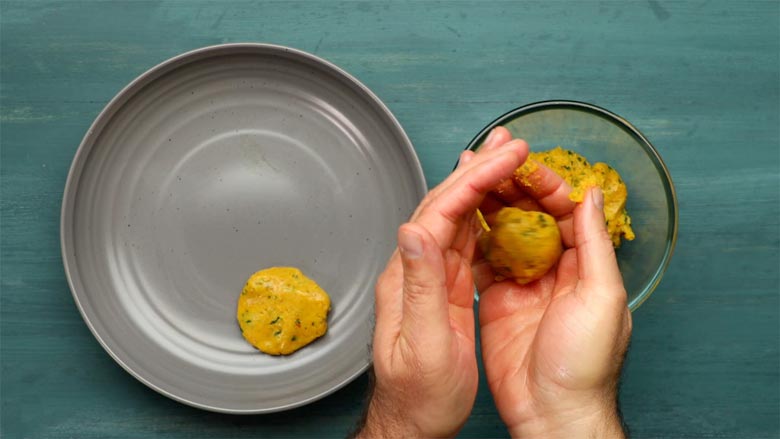 Break off walnut-sized chunks of the potato mixture, roll into a ball between your palms, then flatten to form a smooth disk - Aloo Chop Recipe