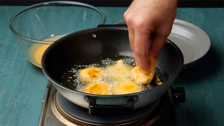 Dip aloor chops in batter and fry them in hot oil - Aloo Chop Recipe