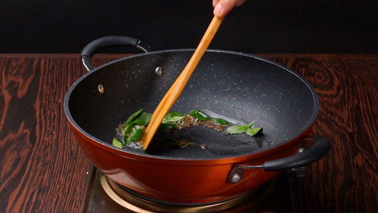 Add cumin seeds, green chillies, ginger paste, and curry leaves to the hot oil in a kadhai - Sabudana Khichdi Recipe
