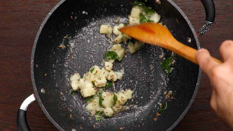 Slide in potatoes and stir fry for about a minute - Sabudana Khichdi Recipe