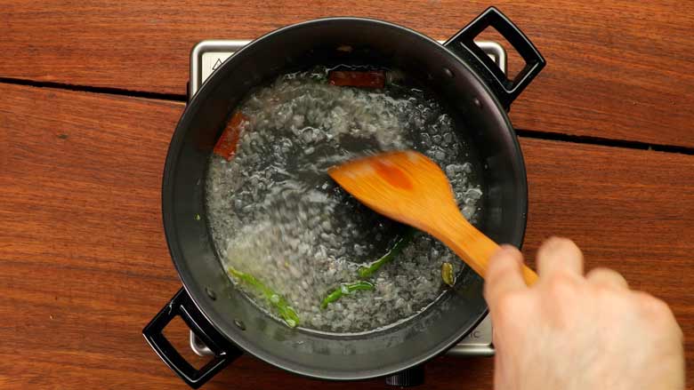 Heat oil, then add cinnamon, green cardamoms, green chillies and onion. Stir till onions turn translucent - Vegetable Stew Recipe Kerala Style