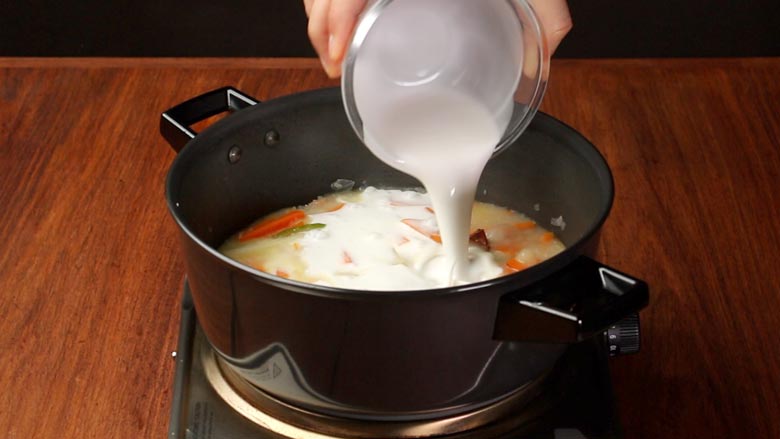 Pour in 1/2 cup water and thick coconut milk - Vegetable Stew Recipe Kerala Style