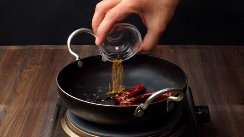 Dry roasting spice masalas in an iron kadhai over medium-low heat for Tamarind Rice