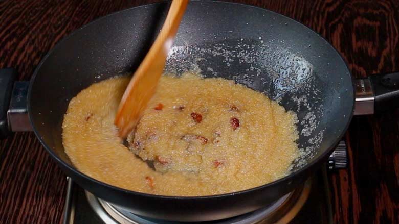 The suji ka halwa is cooked and the black kadhai is ready to be taken off the heat - just a final stir with a wooden spatula - Suji Halwa recipe