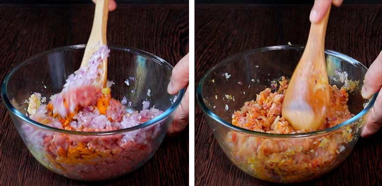 Keema being mixed with spice powders and onions on a wooden spatula in a large glass bowl on a wooden table - Keema Curry Recipe Konkani Style