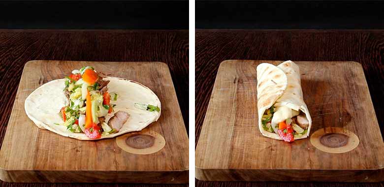 Lightly toasted Lebanese bread with all ingredients including chicken and pickled vegetables in a 2-inch strip across the center lies on a wooden cutting board on a dark wood countertop in the left image while on the right the wrapped and rolled shawarma lies on the same cutting board ready to eat - Homemade Chicken Shawarma Recipe
