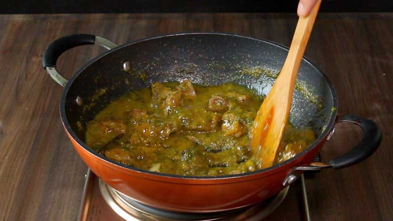 Cook the easy meat curry in a non stick pan stirring with a wooden spatula till the curry has thickened - Spicy Meat Curry Recipe Mirch Kaliya